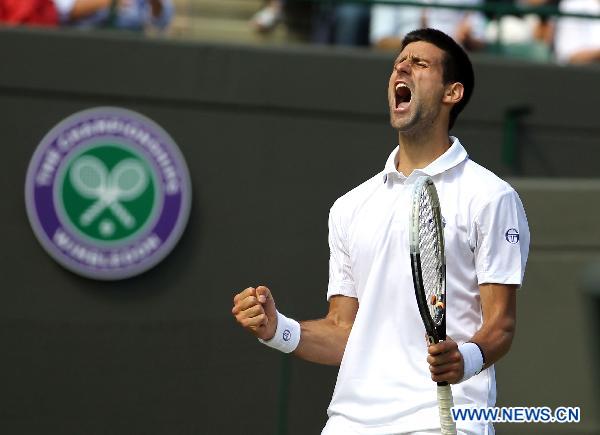 Novak Djokovic of Serbia celebrates a point during his quarterfinal match against Bernard Tomic of Australia in 2011's Wimbledon Championships in London, Britain, June 29, 2011. Djokovic won 3-1 to enter the semifinals. (Xinhua/Tang Shi)