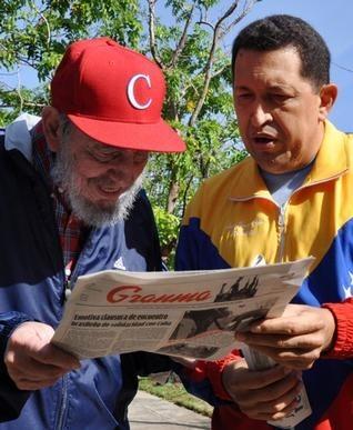 In this photo released by the state media Cubadebate web site, Cuba's Fidel Castro (left) and Venezuela's President Hugo Chavez look at Granma state newspaper at an unknown location in Havana, Cuba, on Tuesday.