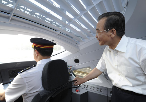 Premiere Wen Jiabao inspects the driver's cabin while travelling on the first bullet train of the landmark high-speed railway from Beijing to Shanghai, June 30, 2011.