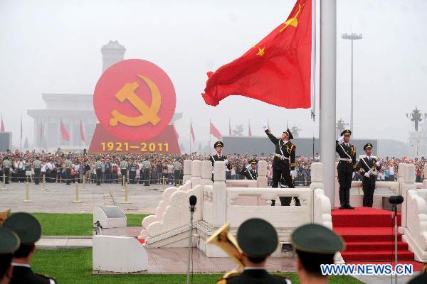 Photo taken on July 1, 2011 shows the national flag of China rises to the music of the national anthem at Tiananmen Square in Beijing, capital of China.