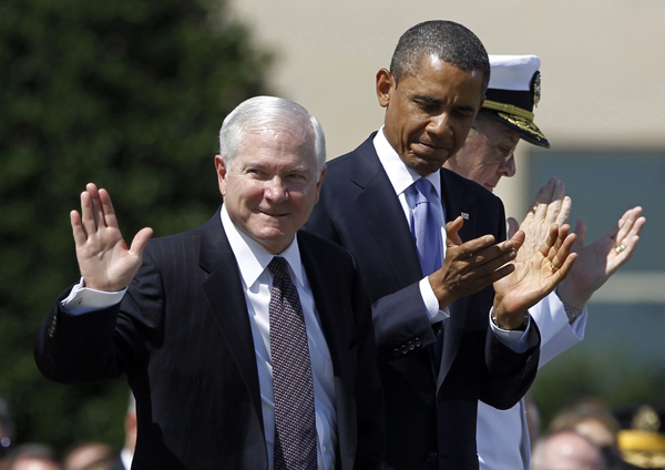 Retiring U.S. Defense Secretary Robert Gates acknowledges applause as U.S. President Barack Obama and Chairman of the Joint Chiefs of Staff Admiral Mike Mullen (obscured) participate in Gates' farewell ceremony at the Pentagon near Washington, June 30, 2011. Gates will be replaced by former CIA Director Leon Panetta. 