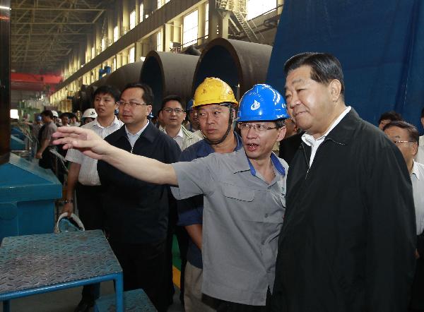 Jia Qinglin (R, front), a member of the Standing Committee of the Political Bureau of the Communist Party of China (CPC) Central Committee and also chairman of the Chinese People's Political Consultative Conference (CPPCC) National Committee, visits a company of the China First Heavy Industries (CFHI) in Dalian City, northeast China's Liaoning Province, July 2, 2011. Jia Qinglin made an inspection tour in Dalian from July 1 to 2. [Ju Peng/Xinhua]