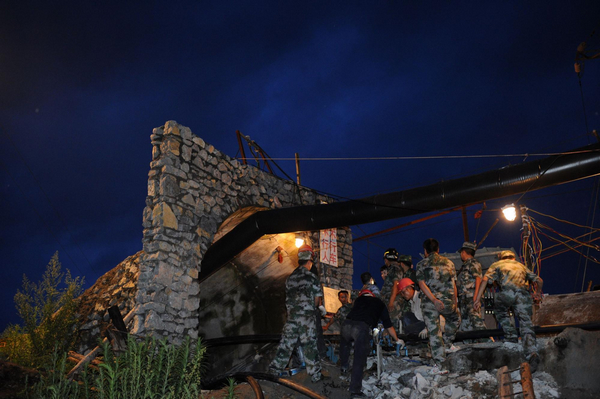 Rescuers are seen at the entrance to a collapsed coal mine in Pingtang of southwest China's Guizhou province, July 2, 2011. [Xinhua]