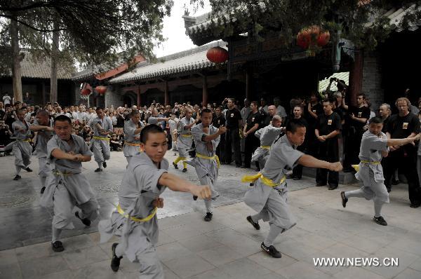 The Shaolin monks perform Kongfu at the Shaolin Temple in Dengfeng, central China's Henan Province July 3, 2011. A group of 138 members of United Studios of Self Defense (USSD) visited the Shaolin Temple, the birthplace of modern martial arts and performed with Shaolin monks on Sunday. [Li Bo/Xinhua]