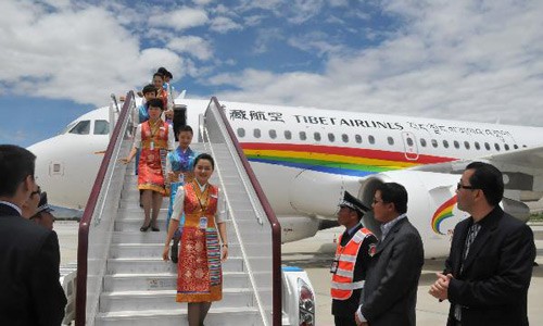 Stewardesses of the Tibet Airlines walk off the ladder as the first A319 plane of Tibet Airlines arrived at Gonggar Airport in Lhasa, capital of southwest China's Tibet Autonomous Region, July 2, 2011. European aircraft manufacturer Airbus on Friday delivered an A319 to Tibet Airlines, making the newly established Chinese airline the newest operator of Airbus in China. Photo: Xinhua