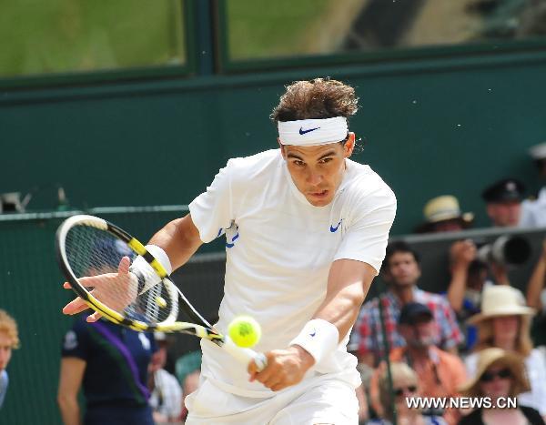 Rafael Nadal of Spain returns a shot during the final of men's singles against Novak Djokovic of Serbia in 2011 Wimbledon Championships in London, Britain, July 3, 2011. Nadal lost 1:3. (Xinhua/Zeng Yi) 