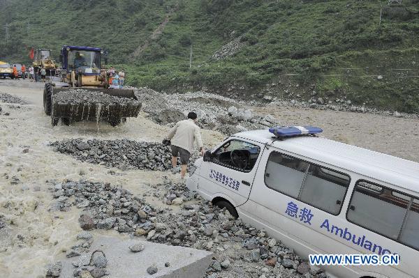 An ambulance is stuck in rain-triggered mudslides on a damaged highway in Wenchuan County, southwest China&apos;s Sichuan Province, July 4, 2011. 