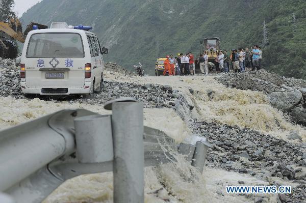 An ambulance stops on a highway damaged by rain-triggered mudslides in Wenchuan County, southwest China&apos;s Sichuan Province, July 4, 2011. 