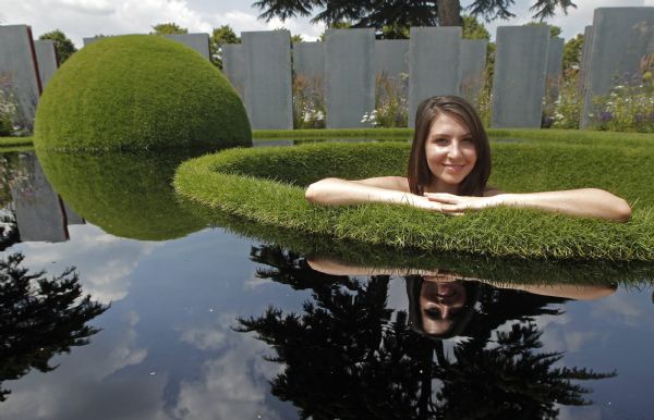 A model poses for a photograph in the World Vision Garden on press day at the Hampton Court Palace Flower Show at Kingston-upon-Thames in south west London A model poses for a photograph in the World Vision Garden on press day at the Hampton Court Palace Flower Show at Kingston-upon-Thames in south west London July 4, 2011. (Xinhua/Reuters)