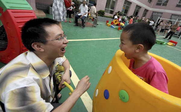 A father plays with his boy in Guiyang, Guizhou province. For children from 'quasi-single-parent families', playing with their fathers is precious. 