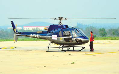 A helicopter prepares to take off at Badaling Airport in Beijing on June 29. Visitors can now have a bird's eye view of the Great Wall from the chopper. Zheng Yong / for China Daily