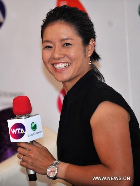 Li Na of China, the first Asian to win a Grand Slam title at the French Open, is interviewed by reporters before a celebration organized by the Women's Tennis Association (WTA) at Sanlitun SOHO in Beijing, China, July 5, 2011. (Xinhua/Gong Lei)