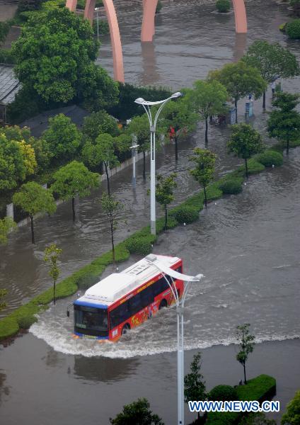 A bus runs on a waterlogged street in Yangzhou, east China&apos;s Jiangsu Province, July 5, 2011. A heavy rainfall caused the flood in Yangzhou on Tuesday. 