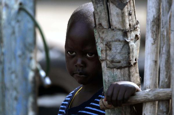  boy stands outsides home in the southern Sudanese city of Juba, July 8, 2011. Sudanese government on Friday officially announced its recognition of South Sudan as an independent state with sovereignty as of Saturday based on the borderline of Jan. 1, 1956. (Xinhua/Nasser Nouri)