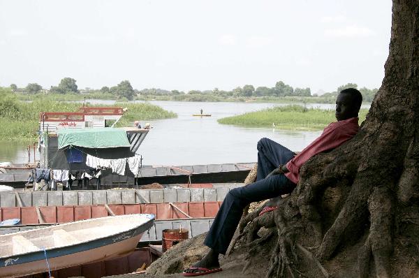 A man sits near a river in the southern Sudanese city of Juba, July 8, 2011. Sudanese government on Friday officially announced its recognition of South Sudan as an independent state with sovereignty as of Saturday based on the borderline of Jan. 1, 1956. (Xinhua/Nasser Nouri)