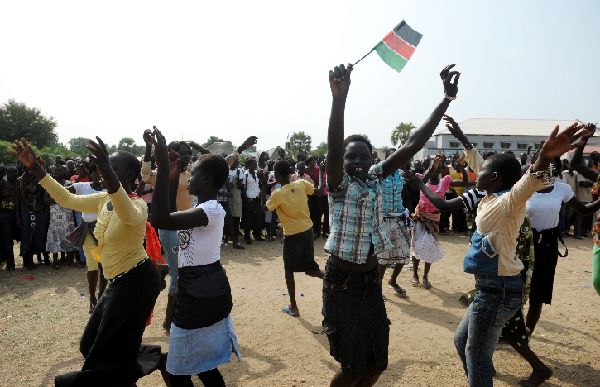 A schoolgirl waves a South Sudanese flag as students practice their routine for independence celebrations in Juba on July 8, 2011, a day before South Sudan secedes from the north and becomes the world's newest nation. 
