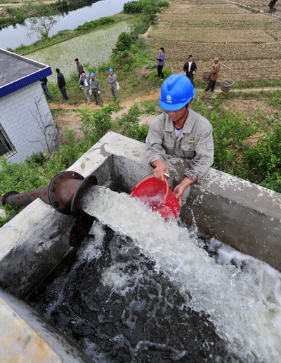 A worker repairs an irrigation pumping station in Dahuangwan village, Wuhan, capital of Hubei province, in May. [China Daily]