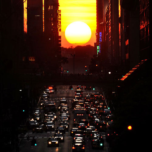 The sun shines down 42nd Street in New York City during the biannual occurrence named 'Manhattanhenge', ...'Manhattanhenge', which was named by astrophysicist Neil deGrasse Tyson, occurs when the setting sun aligns itself with the east-west grid of streets in Manhattan, allowing the sun to shine down all streets at the same time. [Agencies]