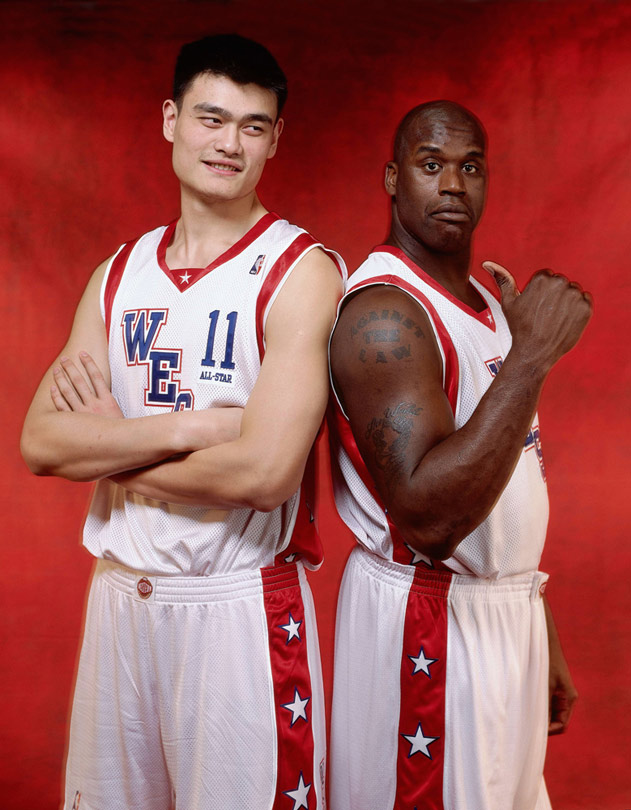 Yao Ming and Shaquille O'Neal pose for photos at the 2004 NBA All-Star Weekend. 