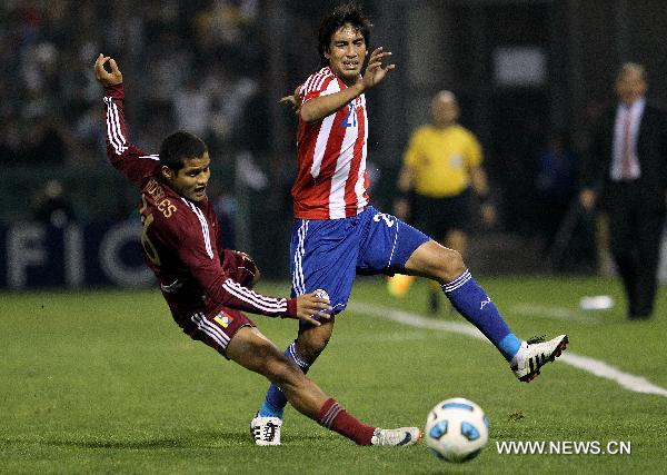 Paraguay's player Marcelo Estigarribia (R) fights for the ball with Roberto Rosales of Venezuela during the match for the group stage of Copa America 2011, in Salta, Argentina, on July 13, 2011. (Xinhua/Santiago Armas) 