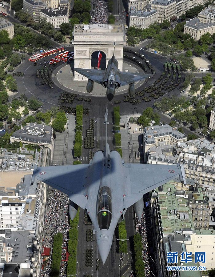 A French Rafale jet flies over the Paris Arch of Triumph (Arc de Triomphe) accompanied by three Mirage 2000-N on July 14, 2011 during the Bastille Day military parade. 