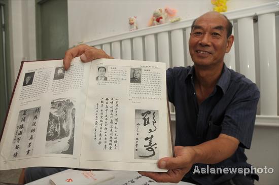 Niu Yinlu displays his published calligraphy work in Hantai town, Xinle city, North China's Hebei province, July 14, 2011.