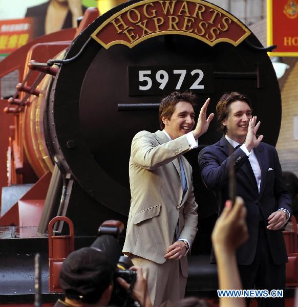 Cast members of 'Harry Potter and the Deathly Hallows - Part 2' James Phelps (R) and Olive Phelps, who portray the Weasley brothers, interact with fans in Hong Kong, south China, July 16, 2011. James and Olive Phelps came to Hong Kong on Saturday to promote the movie 'Harry Potter and the Deathly Hallows - Part 2.' 