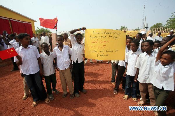 Local children attending the inauguration ceremony of the China-Sudan Friendship Hospital for Maternity and Child Care hold a thanks card in Gezira state, Sudan, July 16, 2011. Sudan's central Gezira state and the Sudanese ministry of health on Saturday celebrated the inauguration of the China-Sudan Friendship Hospital for Maternity and Child Care in Abu Ushar area, which was built in cooperation with China Foundation for Poverty Alleviation (CFPA). 