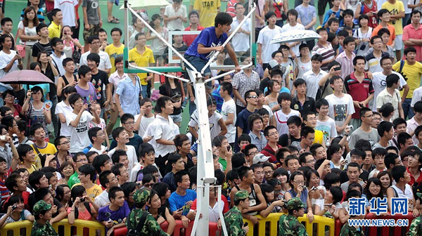 NBA basketball player Kobe Bryant of the Los Angeles Lakers meets fans upon his arrival at a stadium during his 2011 China Tour in Changsha, Central China's Hunan Province, July 16, 2011.