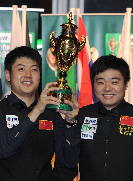 Members of the Chinese snooker team, Ding Junhui (R) and Liang Wenbo pose with the King's trophy after winning against Northern Ireland in the final round of the PTT-EGAT Snooker World Cup 2011, in Bangkok, on July 17, 2011. The Chinese snooker team won 4-2 frames.(Xinhua/AFP Photo)