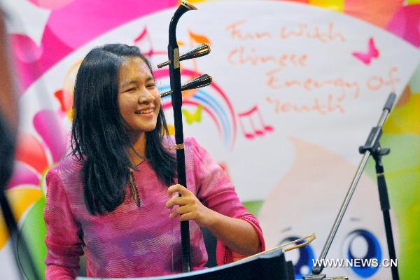 A contestant plays the Erhu, a two-stringed bowed traditional Chinese music instrument, during the Chinese language proficiency competition in Kuala Lumpur, Malaysia, on July 17, 2011. The Malaysian round of the Fourth 'Chinese Bridge' -- Chinese Proficiency Competition for High School Students took place here on Sunday with the participation of 16 contestants.