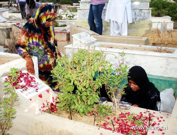 Muslims pray at a graveyard during the Shab-e-Barat Festival in Karachi, a port city in southern Pakistan, July 17, 2011. Muslims visit ancestral graveyards for the salvation of the departed souls and also believe that all sins will be forgiven by praying to Allah throughout the Shab-e-Barat night. [Xinhua Photo/Masroor]