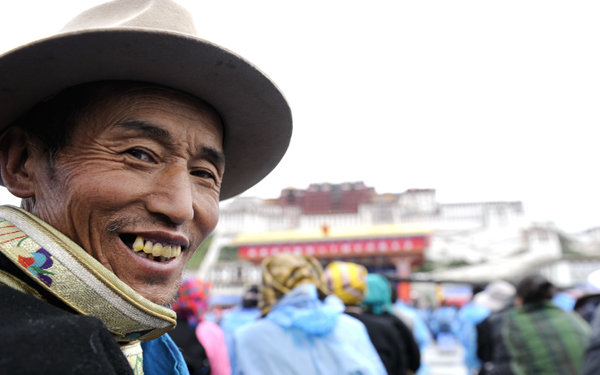 The celebration conference marking the 60th anniversary of Tibet's peaceful liberation is held in Lhasa, capital of southwest China's Tibet Autonomous Region, on July 19, 2011. In the picture a Tibetan waits for the opening of the celebration ceremony. 