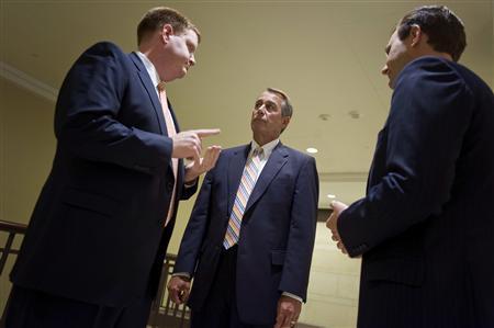 House Speaker John Boehner huddles with aides before leading fellow Republicans for a news conference about their proposed deficit-cutting plan, at the U.S. Capitol in Washington, July 19, 2011.