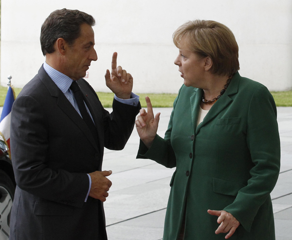German Chancellor Angela Merkel (R) welcomes France's President Nicolas Sarkozy before talks in Berlin, July 20, 2011. Merkel believesThursday's summit of euro zone leaders will agree on a new Greek bailout, while her talks with France's Nicolas Sarkozy later on Wednesday will help Europe find such a solution, an aide said. [Xinhua]