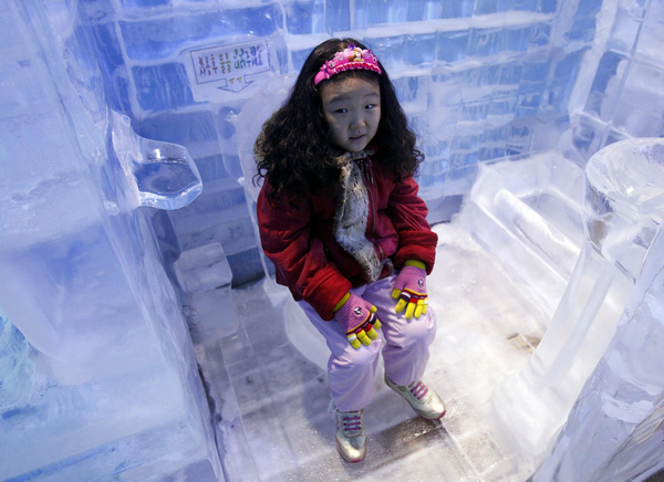 A girl sits on an ice toilet at the Ice Gallery in Seoul July 20, 2011. South Korea&apos;s National Meteorological Administration issued a nationwide scorching heat warning recently, local media reported.[Photo/Agencies]