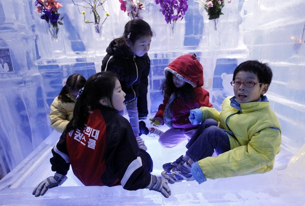 Children play on an ice bed upon their visit at the Ice Gallery in Seoul July 20, 2011. South Korea&apos;s National Meteorological Administration issued a nationwide scorching heat warning recently, local media reported. [Agencies]