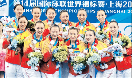 Members of China's team pose with their silver medals after the synchronized swimming free combination final at the Oriental Sports Center in Shanghai last night.  