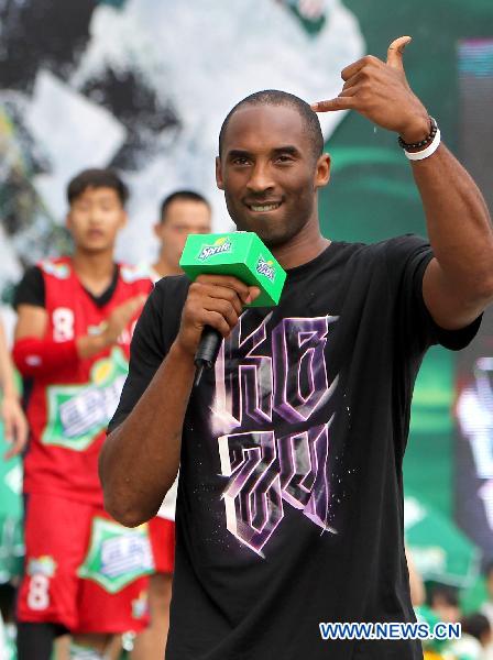 Kobe Bryant greets his fans in east China's Shanghai, July 21, 2011. As part of his Asian tour, NBA star Kobe Bryant met and gave instructions to young Chinese players in the final of a basketball contest Thursday in Shanghai.