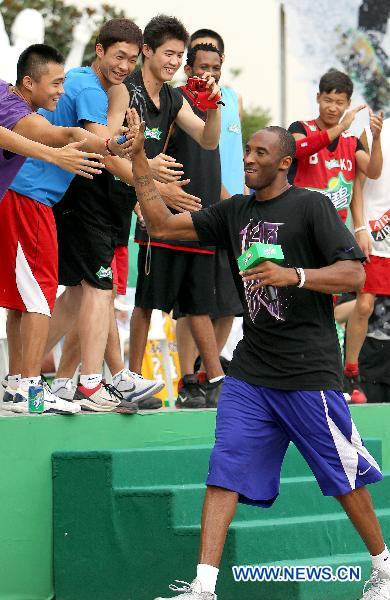 Kobe Bryant greets his fans in east China's Shanghai, July 21, 2011. As part of his Asian tour, NBA star Kobe Bryant met and gave instructions to young Chinese players in the final of a basketball contest Thursday in Shanghai.