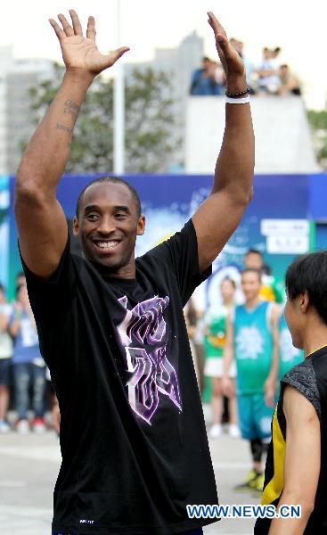 Kobe Bryant greets his fans in east China's Shanghai, July 21, 2011. As part of his Asian tour, NBA star Kobe Bryant met and gave instructions to young Chinese players in the final of a basketball contest Thursday in Shanghai.