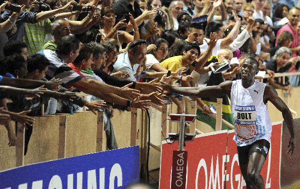 Usain Bolt of Jamaica reacts after winning the men's 100 metres event at the Herculis Diamond League athletics meeting at Louis II stadium in Monaco July 22, 2011. [Xinhua]