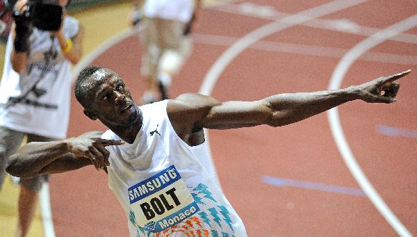 Usain Bolt of Jamaica reacts after winning the men's 100 metres event at the Herculis Diamond League athletics meeting at Louis II stadium in Monaco July 22, 2011. [Xinhua]