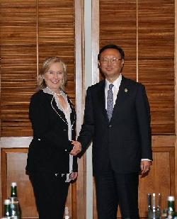 Foreign Minister Yang Jiechi speaks with US Secretary of State Hillary Clinton before a meeting on the Indonesian island of Bali on Friday. [Xinhua]