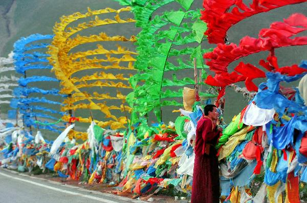 A lama looks into the distance at the tourist site of the Riyue Mountain in northwest China's Qinghai Province, July 20, 2011. Tourist arrivals to Qinghai are picking up as the summer holiday season starts. (Xinhua/Wang Song) 