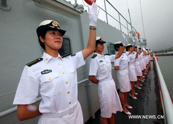 Women navy trainees on Zheng He training ship wave bye as they are ready to set off sailing in a harbor in Dalian, northeast China's Liaoning Province, July 25, 2011. A fleet formed by China's naval Zheng He training ship and Luoyang missile frigate set sail from Dalian on Monday for a visit to Russia and the Democratic People's Republic of Korea. (Xinhua/Zha Chunming) (cxy) 