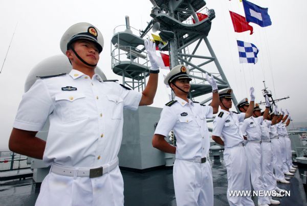 Navy trainees on Zheng He training ship wave bye as they are ready to set off sailing in a harbor in Dalian, northeast China's Liaoning Province, July 25, 2011. A fleet formed by China's naval Zheng He training ship and Luoyang missile frigate set sail from Dalian on Monday for a visit to Russia and the Democratic People's Republic of Korea. (Xinhua/Zha Chunming) (cxy) 