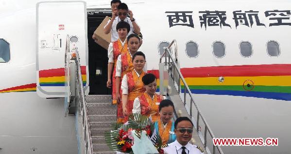 The crew members walk out of Tibet Airlines Flight TV9807 after its maiden voyage from Lhasa to Kunsha Airport in Ngari Prefecture, southwest China's Tibet Autonomous Region, July 26, 2011. Tibet Airlines, the first airline based in Tibet Autonomous Region, made its maiden flight on Tuesday from Gonggar Airport in Lhasa to Kunsha airport in Ngari Prefecture. [Xinhua/Wang Jianhua] 