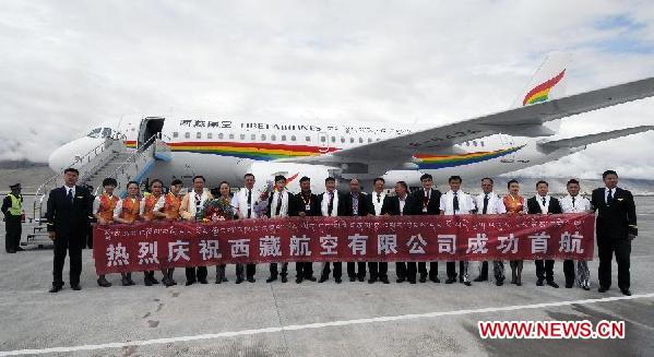 The crew members pose for a photo after the maiden voyage of Tibet Airlines Flight TV9807 from Lhasa to Kunsha Airport in Ngari Prefecture, southwest China's Tibet Autonomous Region, July 26, 2011. Tibet Airlines, the first airline based in Tibet Autonomous Region, made its maiden flight on Tuesday from Gonggar Airport in Lhasa to Kunsha airport in Ngari Prefecture.[Xinhua/Wang Jianhua]