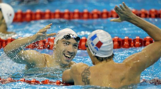 France's Camille Lacourt (L) and compatriot Jeremy Stravius celebrate after the men's 100m backstroke final at the 14th FINA World Championships in Shanghai July 26, 2011.